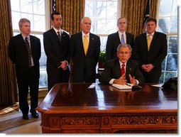 President George W. Bush speaks to the press after the signing of the 2008 Economic Report Monday Feb. 11, 2008, in the Oval Office. Joining President Bush are, from left, Chuck Blahous, Deputy Assistant to the President for Economic Advisors; Pierce Scranton, Chief of Staff, Council of Economic Advisors; Eddie Lazear, Chairman, Council of Economic Advisors; Donald Marron, Senior Economic Advisor, Council of Economic Advisors; and Keith Hennessey, Assistant to the President for Economic Policy. White House photo by Joyce N. Boghosian