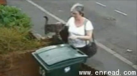 The woman is seen throwing the cat in the wheelie bin before walking away.