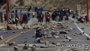 Hundreds of miners and their families blocked off roads by <a href=