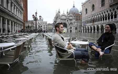 Tourists sit in St. Mark Square during a period of <a href=