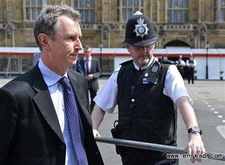 Conservative MP and deputy speaker of Britain\s parliament Nigel Evans (L) arrives to make a news statement outside of the Houses of Parliament in London May 7, 2013.