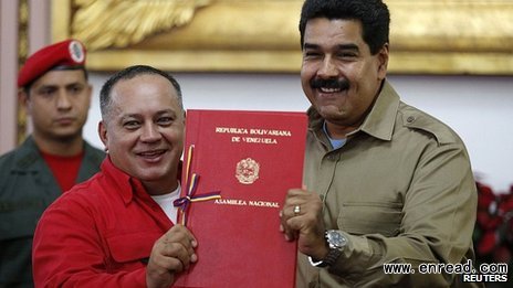 Nicolas Maduro, right, signed the bill watched by National Assembly President Diosdado Cabello