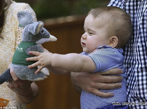 Is that for me? Prince George grabs at a <a href=