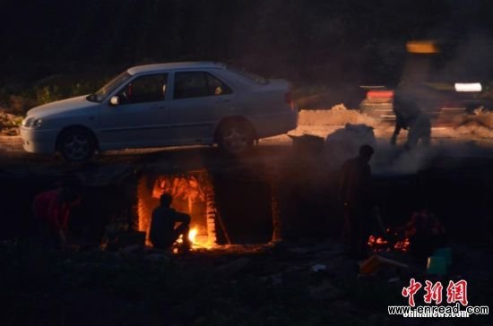 Residents smoke their bacon at designated spots by the government in Dazhou in the neighboring Sichuan province on Jan. 20, 2015.