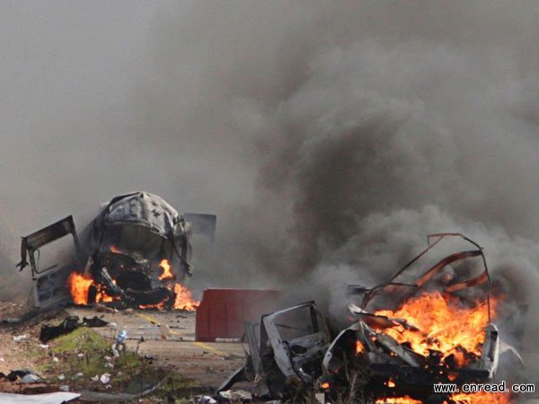 Burning vehicles are seen near the village of Ghajar on Israel's border with Lebanon January 28, 2015.