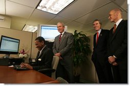 President George W. Bush is joined by Secretary Michael Chertoff, right, of the Department of Homeland Security, and Secretary Carlos Gutierrez of the Department of Commerce, as they look on during a demonstration Wednesday, May 16, 2007, of the Basic Pilot/Employment Eligibility Verification System, a voluntary program managed by U.S. Citizenship and Immigration Services that allows employers to electronically verify the eligibility of newly hired employees. The demonstration, led by Glenda Wooten-Ingram, Director of Human Resources, was held at the Embassy Suites Washington, D.C.-Convention Center, and was followed by a roundtable discussion of the program. White House photo by Joyce Boghosian