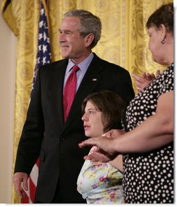 President George W. Bush embraces stem cell patient Kaitlyne McNamara following his address on the reasons he vetoed S.5, the Stem Cell Research Enhancement Act of 2007, in the East Room of the White House Wednesday, June 20, 2007. McNamara was born with spina bifida, a disease that damaged her bladder, her doctors isolated healthy stem cells in a piece of her own bladder and used them to grow her a new bladder.  White House photo by Eric Draper