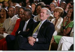 President George W. Bush, entrepreneur Bob Johnson, left, and invited guests respond to entertainers Friday, June 22, 2007 in the East Room of the White House, in celebration of Black Music Month.  White House photo by Eric Draper