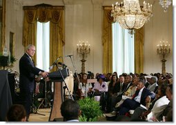 President George W. Bush welcomes guests to the East Room of the White House Friday, June 22, 2007, to join in a celebration of Black Music Month, focusing on the music of hip hop and R &B artists.  White House photo by Eric Draper