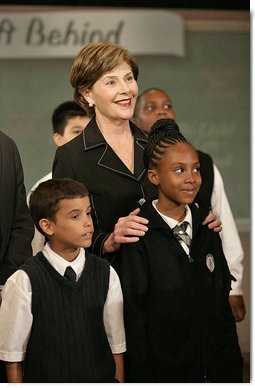 Mrs. Laura Bush stands with students from New York Public School 76 during the Presidents statement regarding No Child Left Behind Wednesday, Sept. 26, 2007, in New York. White House photo by Eric Draper