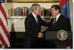 President George W. Bush shakes hands with President Nambaryn Enkhbayar of Mongolia, Monday, Oct. 22, 2007, in the Roosevelt Room of the White House, where the two leaders signed the Millennium Challenge Corporation Compact. Said President Bush: "The Millennium Challenge Compact encourages countries to make a firm commitment to basic principles, principles that mean the government will listen to their people and respond to the needs of the people.We honor the success of your country and the commitment of your government to basic principles." White House photo by Eric Draper