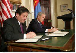 President George W. Bush and President Nambaryn Enkhbayar of Mongolia sign the Millennium Challenge Corporation Compact Monday, Oct. 22, 2007, in the Roosevelt Room of the White House. White House photo by Chris Greenberg