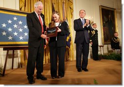 President George W. Bush leads the applause after presenting Dan and Maureen Murphy with the Medal of Honor in honor of their son, Navy Lt. Michael P. Murphy, who died in action during service in support of Operation Enduring Freedom in 2005. White House photo by David Bohrer