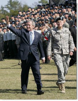 President George W. Bush waves as he and Brigadier General James Schwitters, Commanding General at Fort Jackson, S.C., walk before the graduates Friday, Nov. 2, 2007, during the President's appearance at the Basic Combat Training Graduation Ceremony. White House photo by Eric Draper