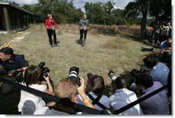 President George W. Bush and German Chancellor Angela Merkel stand before the press following their meeting at the Bush Ranch in Crawford, Texas, Saturday, Nov. 10, 2007. White House photo by Eric Draper