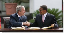 President George W. Bush and President Jakaya Kikwete of Tanzania, shake hands after signing the $698 million Millennium Challenge Compact Sunday, Feb. 17, 2008, in Dar es Salaam. In signing the compact, President Bush said, We are partners in democracy. We believe that governments ought to respond to the people. We're also partners in fighting disease, extending opportunity and working for peace. Mr. President, I mentioned I was proud to sign, along with the President, the largest Millennium Challenge Account in the history of the United States here in Tanzania. It will provide nearly $700 million over five years to improve Tanzania's transportation network, secure reliable supplies of energy, and expand access to clean and safe water. White House photo by Chris Greenberg