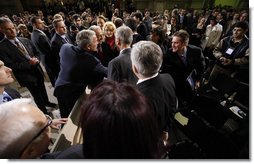 President George W. Bush reaches out to members of the audience Tuesday, April 2, 2008, after he delivered a keynote speech in Bucharest hours before the opening of the two-day NATO Summit.  White House photo by Eric Draper