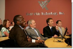 President George W. Bush, seated next to Jim Kavanaugh, right, CEO and co-founder of World Wide Technology, Inc., is shown some of the company's products during a tour of the facility Friday, May 2, 2008, in Maryland Heights, Mo. President Bush also addressed employees and invited guests on the benefit of the stimulus package for the nation's economy. White House photo by Chris Greenberg