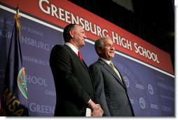 President George W. Bush stands next to Greensburg Schools Superintendent Darin Headrick before making remarks during commencement ceremonies for the Greensburg High School graduating class of 2008. The town of Greensburg, KS was almost entirely destroyed when a tornado tore through the town one year ago today. White House photo by Chris Greenberg