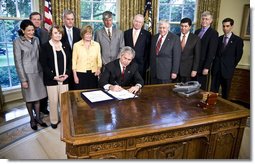 President George W. Bush signs H.R. 493, the Genetic Information Nondiscrimination Act of 2008, Wednesday, May 21, 2008, in the Oval Office. The Genetic Information Nondiscrimination Act would prevent health insurers from canceling, denying, refusing to renew, or changing the terms or premiums of coverage based solely on a genetic predisposition toward a specific disease. The legislation also bars employers from using individuals genetic information when making hiring, firing, promotion, and other employment-related decisions. White House photo by Eric Draper