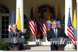 President George W. Bush listens as Colombian President Alvaro Uribe speaks to a reporter Saturday, Sept. 20, 2008, during a joint press availability in the Rose Garden at the White House. White House photo by Eric Draper