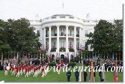 President George W. Bush and Prime Minister Silvio Berlusconi stand together on the reviewing stand Monday, Oct. 13, 2008 on the South Lawn of the White House, as the Old Guard Fife and Drum Corps passes in review during the arrival ceremony to welcome Prime Minister Berlusconi to the White House. White House photo by Chris Greenberg