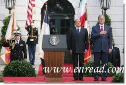 President George W. Bush and Prime Minister Silvio Berlusconi stand together on the reviewing stand Monday, Oct. 13, 2008 on the South Lawn of the White House, during the playing of the National Anthem. White House photo by Chris Greenberg