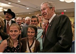 President George W. Bush poses for photos and meets guests following his remarks to the National Cattlemens Beef Association Wednesday, March 28, 2007 in Washington, D.C.  White House photo by Joyce Boghosian