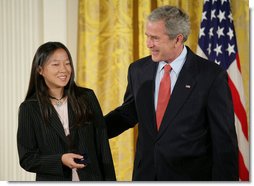 President George W. Bush congratulates Anna DeSanctis of Houston, Texas, after presenting her with the Presidents Volunteer Service Award Thursday, May 10, 2007, in the East Room of the White House, celebrating Asian Pacific American Heritage Month.  White House photo by Eric Draper