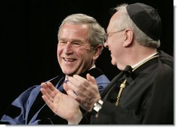 President George W. Bush, sitting with Saint Vincent College Archabbot and Chancellor Rev. Douglas Nowicki, is applauded prior to being introduced Friday, May 11, 2007, to deliver the commencement address to graduates at Saint Vincent College in Latrobe, Pa. White House photo by Joyce Boghosian