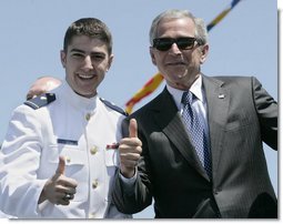 President George W. Bush, wearing the sunglasses of U.S. Coast Guard graduate Steven Matthew Volk, poses with Volk for a thumbs-up photo following the Presidents address to the graduates Wednesday, May 23, 2007, at the U.S. Coast Guard Academy commencement in New London, Conn. White House photo by Joyce Boghosian