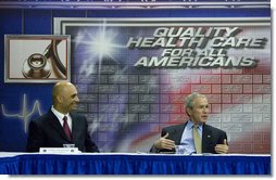 President George W. Bush talks with Clifton Broumand, CEO of Man & Machine, Inc. during in a roundtable discussion about health care initiatives after touring Mr. Broumand's company Wednesday, July 18, 2007, in Landover, Md. White House photo by Chris Greenberg